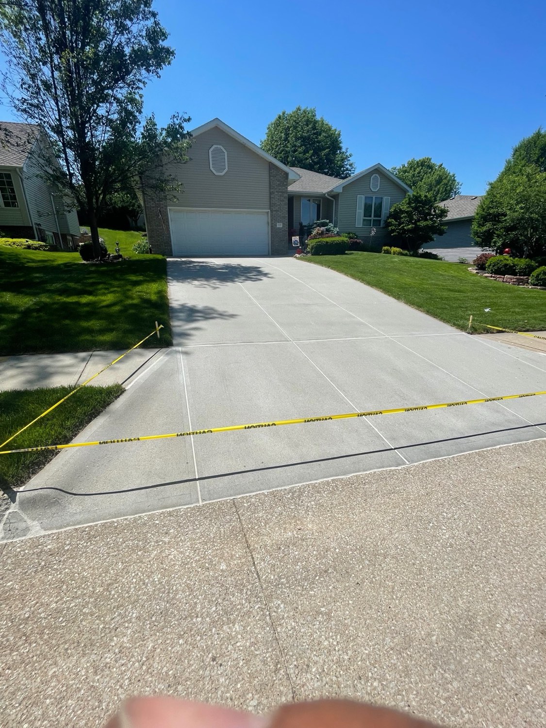 Bright blue sky over a caulked driveway