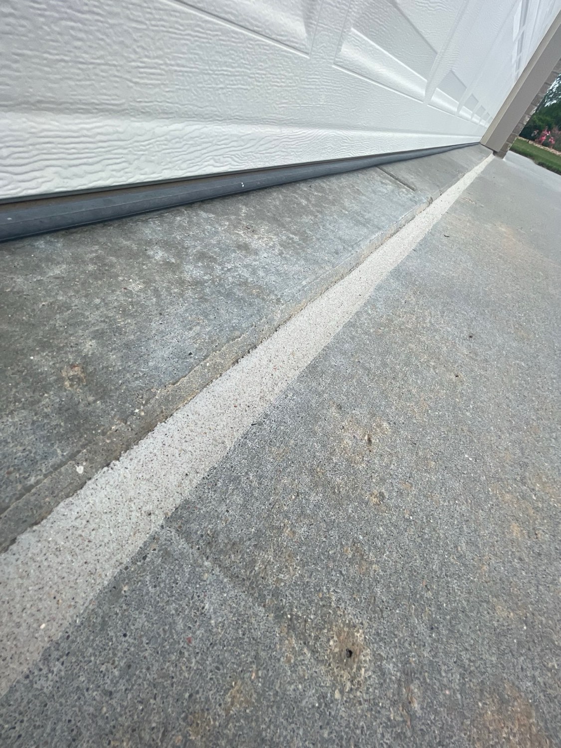 Detail of fresh caulk bead at garage apron