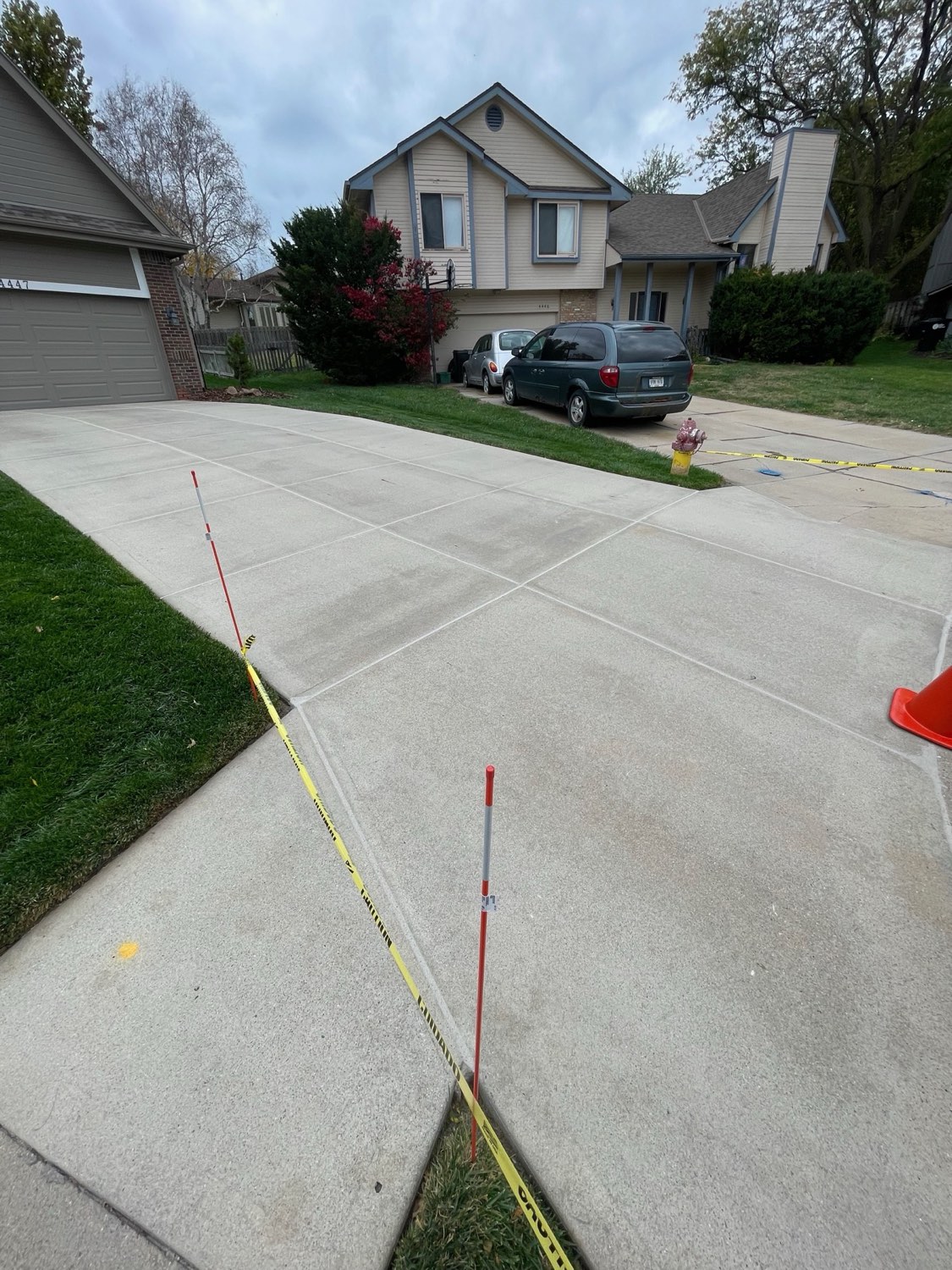 Fall driveway with caulk lines and caution tape