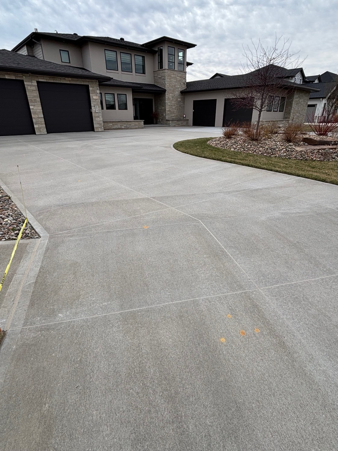 Luxury home 3-car driveway with crisp caulk lines
