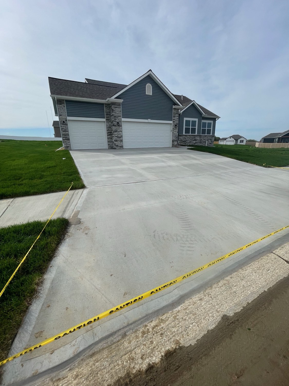 New construction driveway freshly caulked