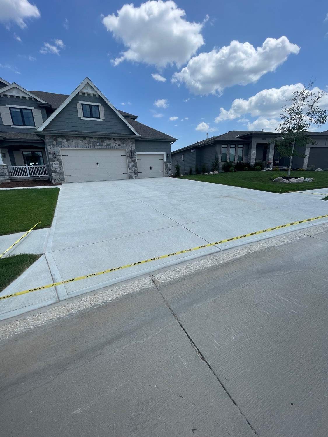 Stone-front home with caulked driveway