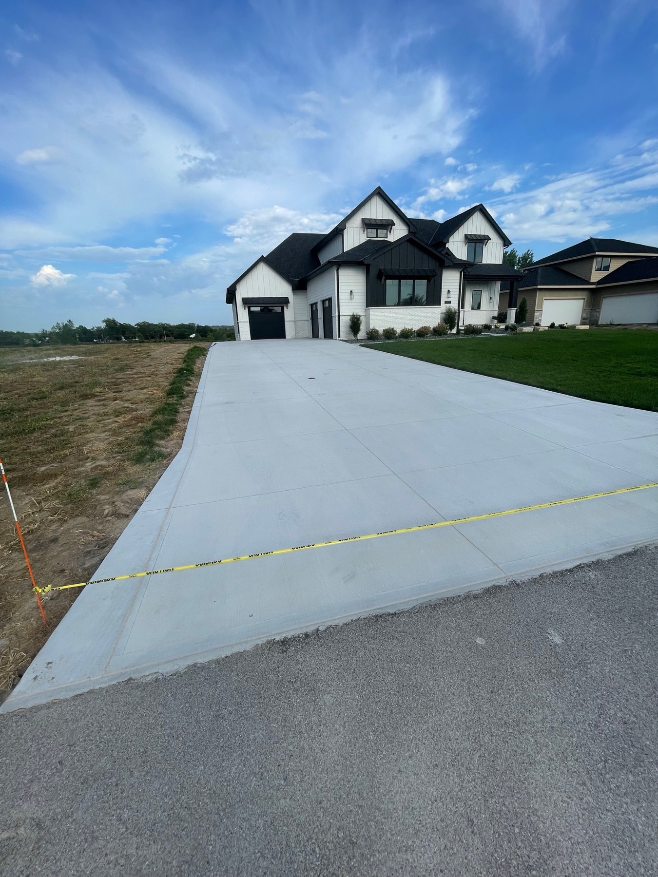 Freshly caulked residential driveway at sunset in Omaha